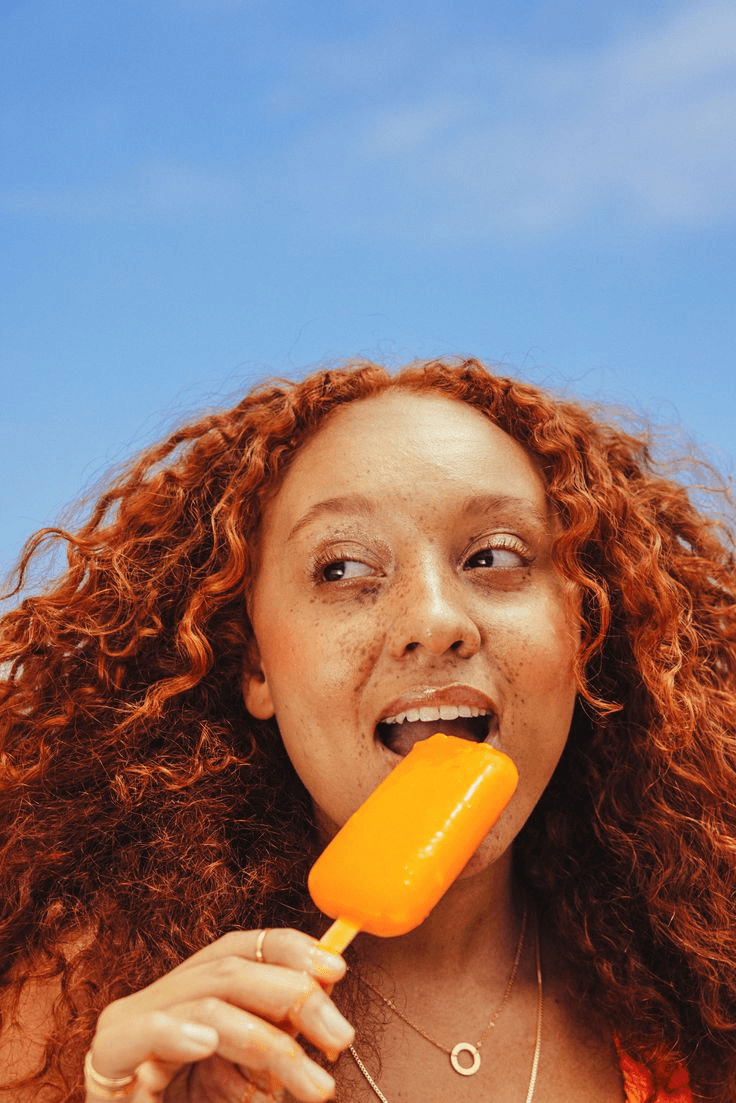 Woman eating popsicle